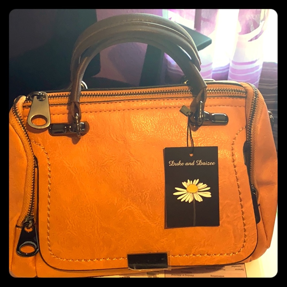 Mini size orange hand bag. It’s new